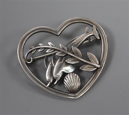 A George Jensen sterling leaping twin dolphin heart shaped brooch, no. 312, 41mm.